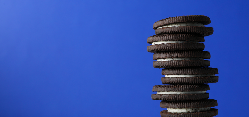 A stack of chocolate sandwich cookies on a plate