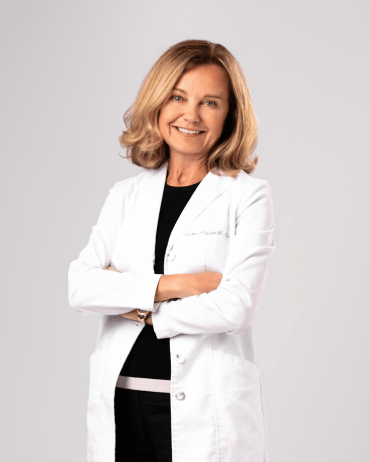 Dr. Elizabeth Klodas wearing a white lab coat on a plain background