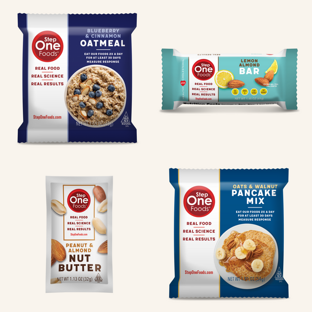 Four packages of Step One Foods products including Blueberry & Cinnamon Oatmeal, Lemon Almond Bar, Peanut & Almond Butter, and Oats & Walnut Pancake Mix.