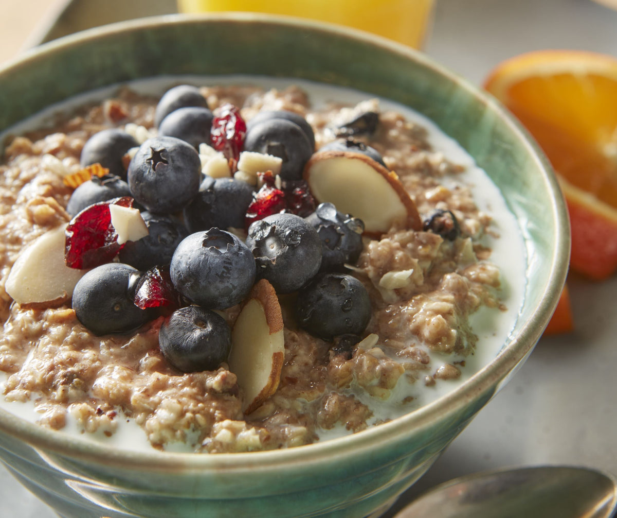 A bowl of oatmeal topped with fresh blueberries