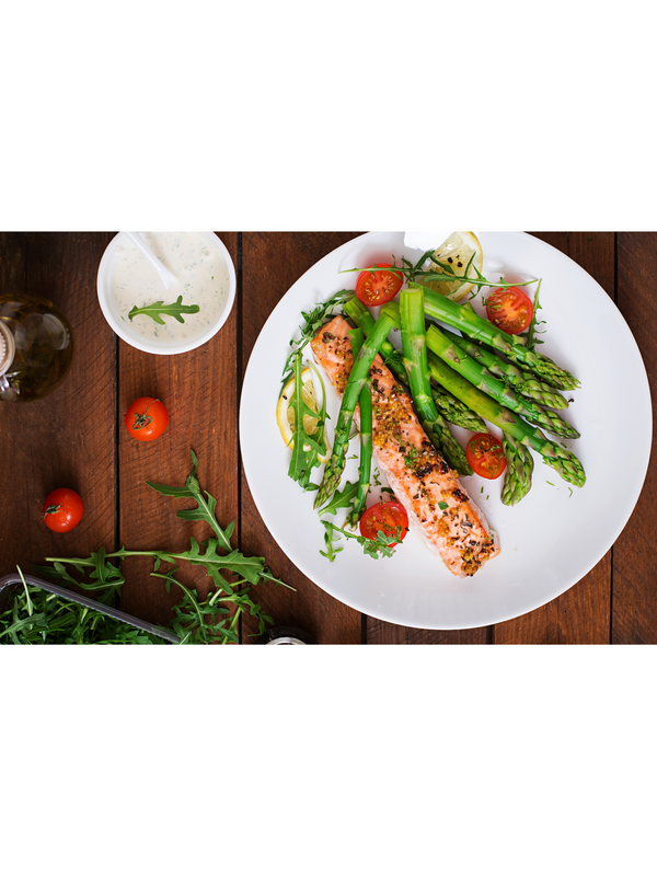 Plate of salmon and asparagus representing a whole-food approach to weight loss