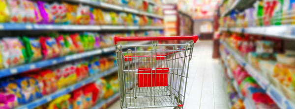 A grocery store aisle lined with packaged foods competing on health claims
