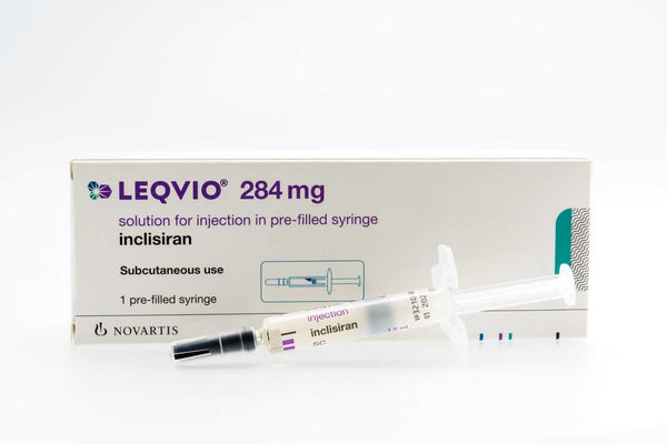 A vial and syringe representing inclisiran (Leqvio), a twice-yearly cholesterol injection